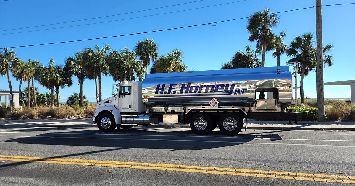 H.F. Horney fuel truck in front of palm trees